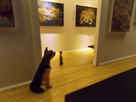 Dogs look at tiger painting